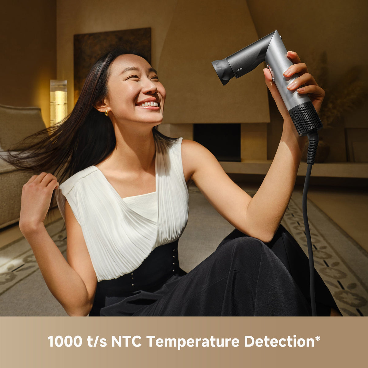 Smiling woman drying her hair with the MOVA Master 10, which checks temperature 1,000 times a second